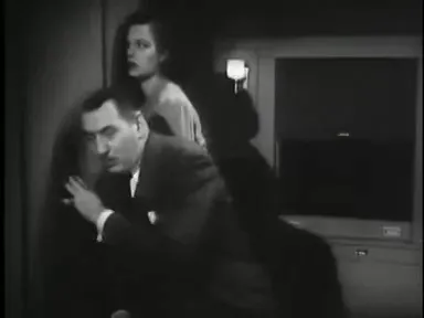 A suspect confronts Lennon in a tense doorway exchange