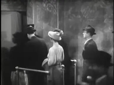 Men stake out the platform while passengers board, a late-night tension
