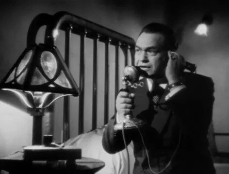 Mr. Wilson on the telephone, following a lead about the fugitive's movements.