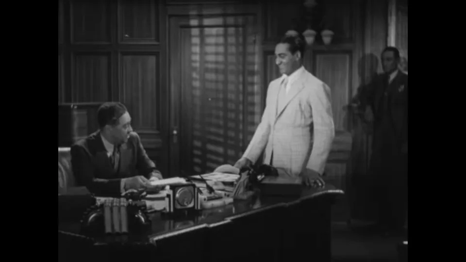 Curly meets Larry Lee in an intimidating, richly furnished office