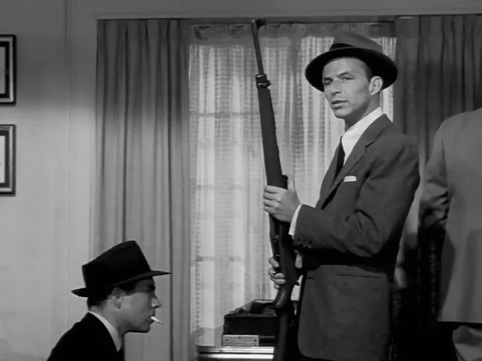 Baron (Sinatra) shows the henchmen the sniper rifle and reveals his wartime recollections