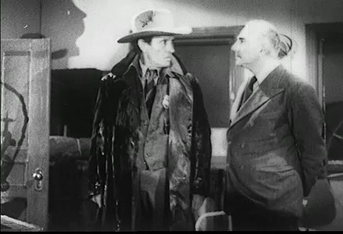 The sheriff confronts the assembled guests after finding a body upstairs.