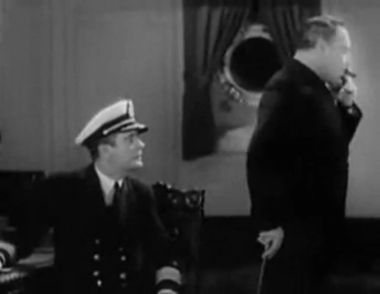 A crew meeting—debate and accusation over the possibility of Captain Holling's presence