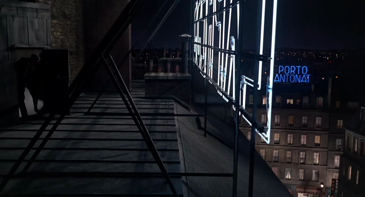 Adam and Reggie in a tense standoff on the hotel rooftop