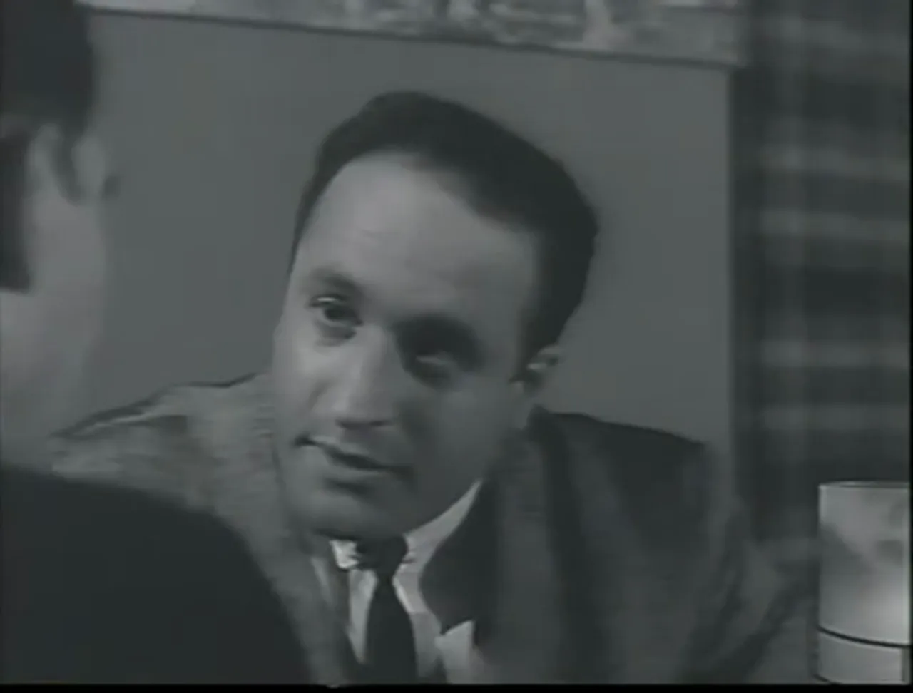 Plot exposition: Dorella outlines the scheme and the five-minute call schedule central to the film noir movie.