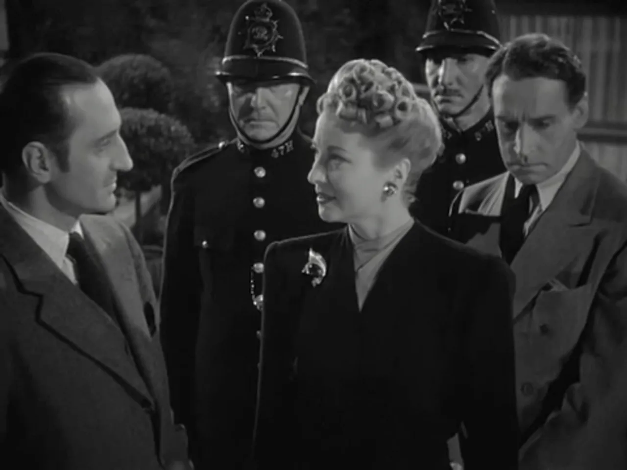 Police taking Moriarty’s henchwoman into custody as Holmes watches