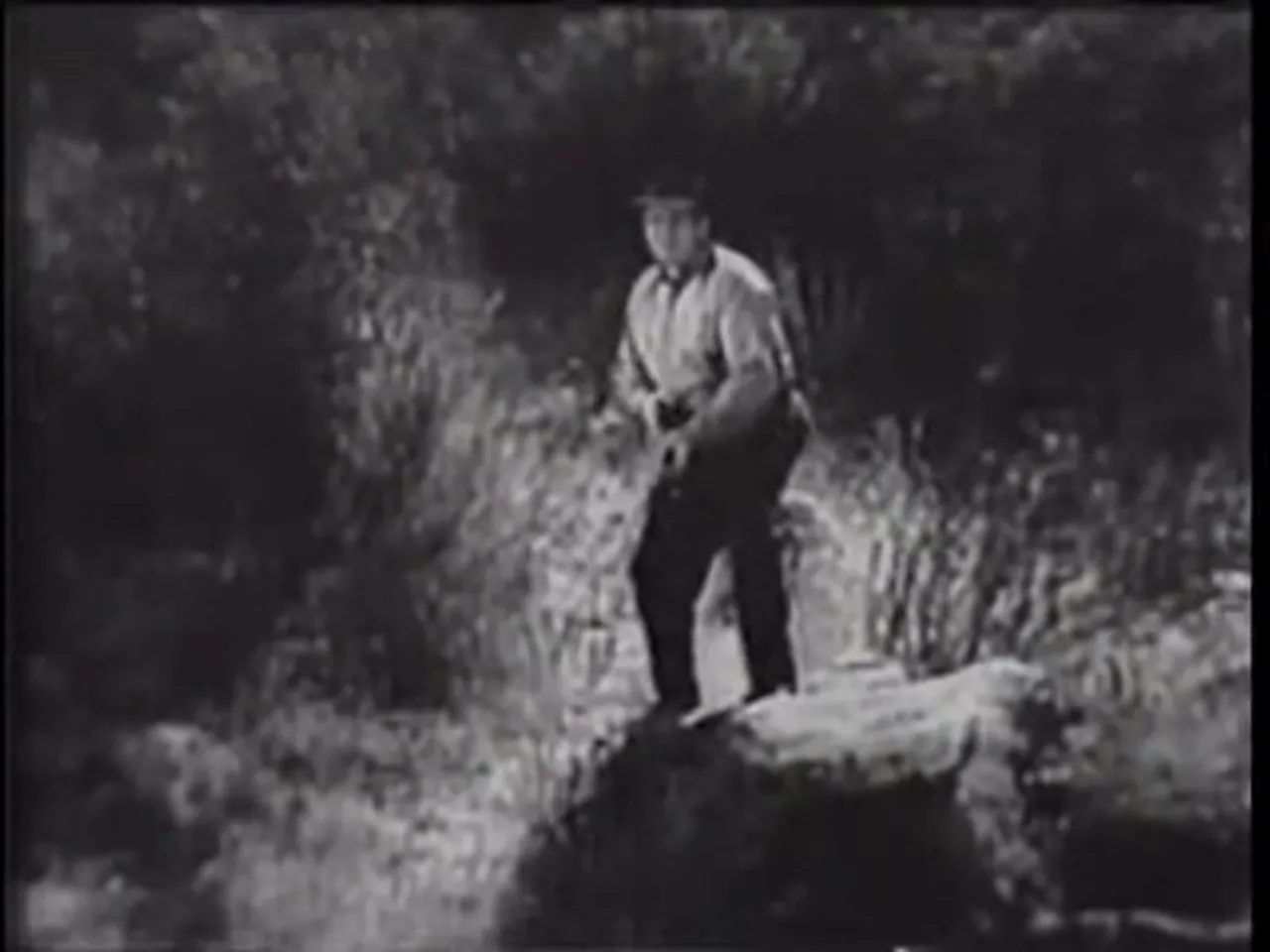 Blackie raising his gun — a final cliffhanger shot