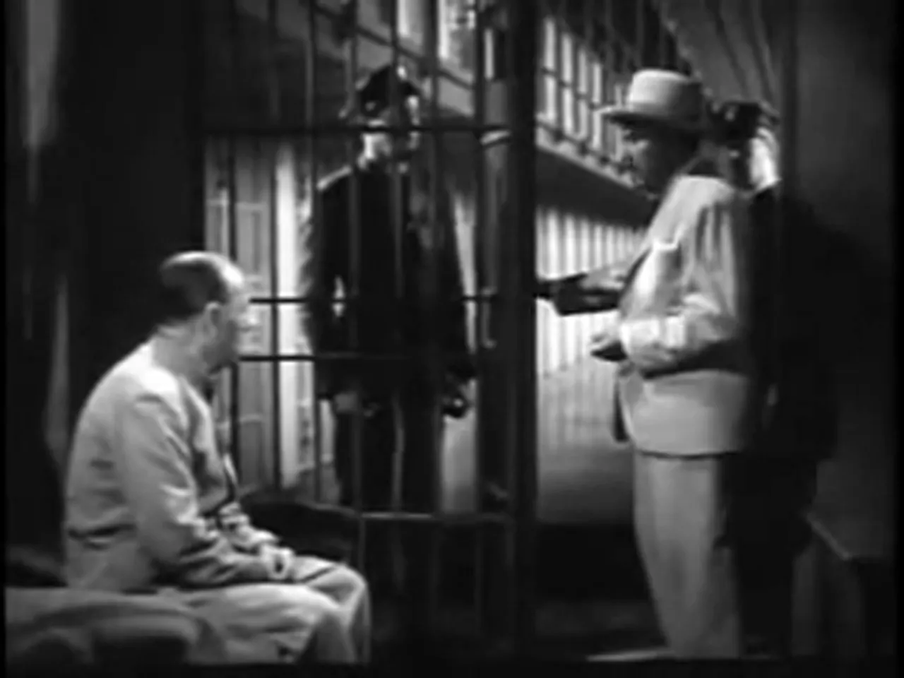 Chan interrogates the warden; the institutional dimension of the film noir movie is foregrounded.