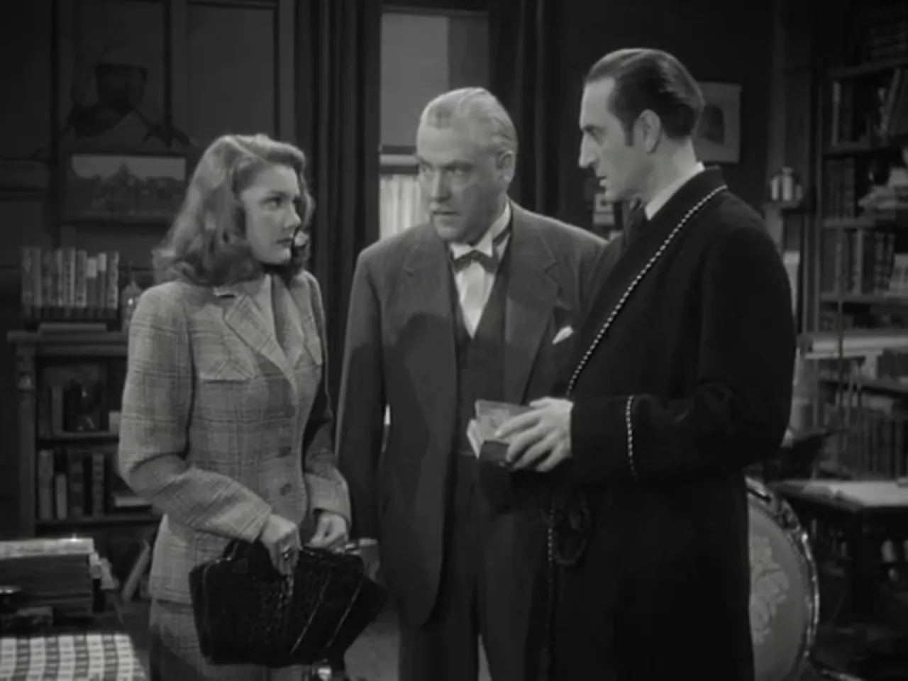 Miss Fenwick presenting a box containing a human forefinger to Holmes and Watson