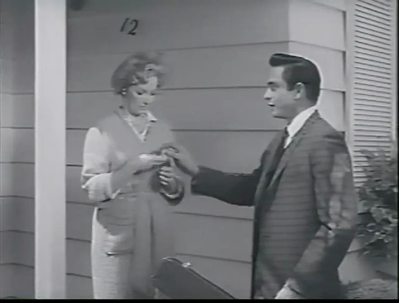 A door-to-door scene: the film noir movie uses quotidian gestures to conceal menace.
