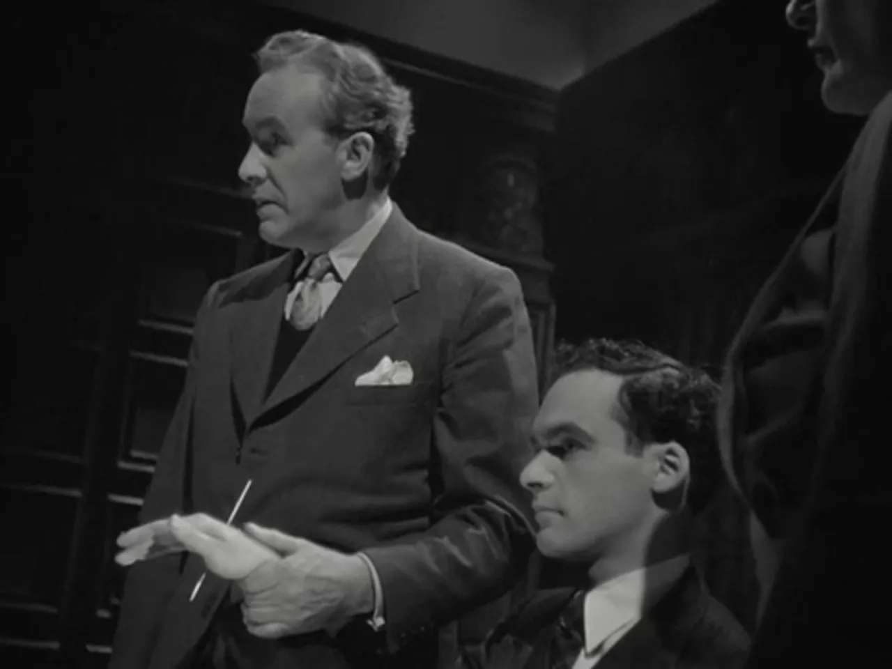A dramatic demonstration at the Mesmer Club where a needle is thrust through a subject’s hand
