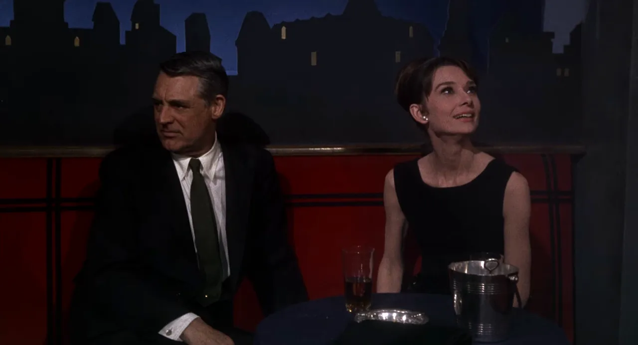 Cary Grant and Audrey Hepburn in a staged ballroom sequence