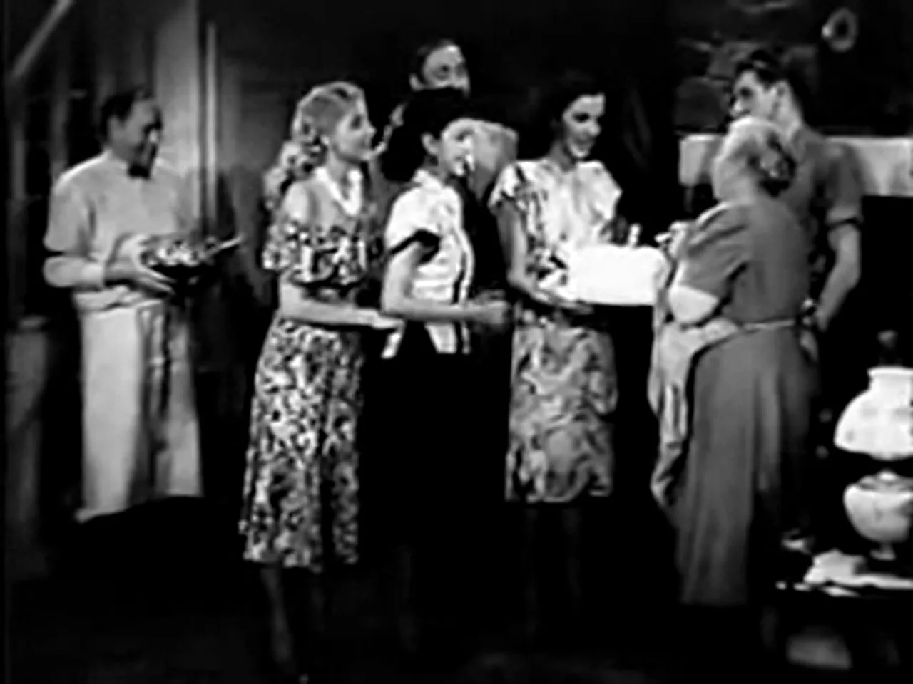 The community celebrates Maggie's birthday; a rare moment of joy in the film noir movie