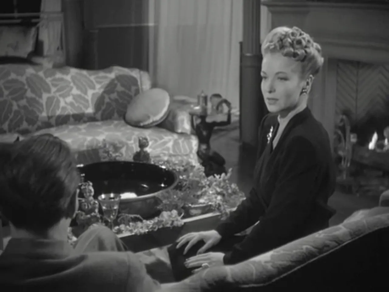 Lydia Marlowe (Hillary Brooke) hypnotizing Holmes during an intimate séance-like scene