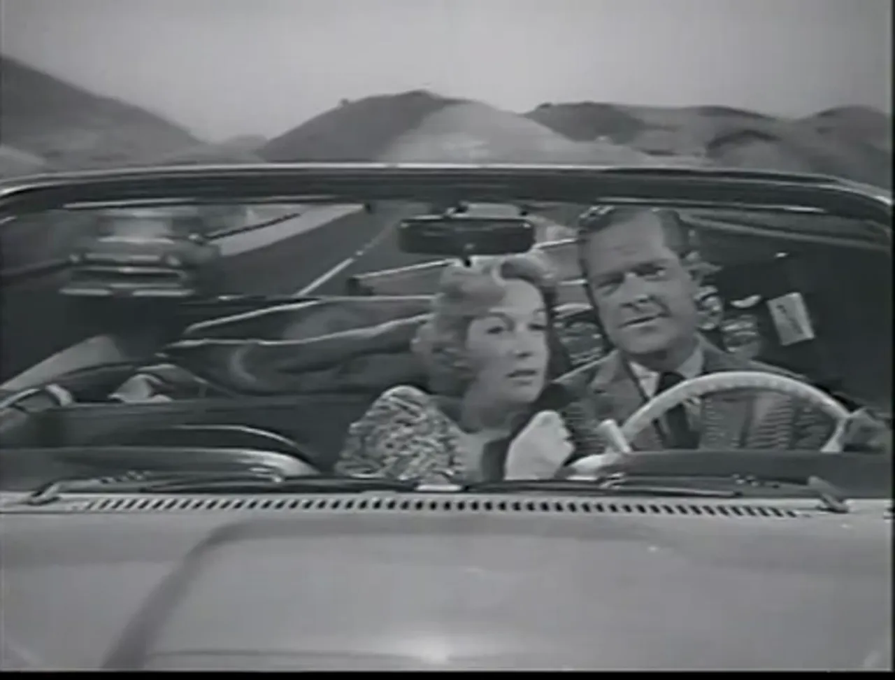 Post-climax resolution—Ken and Nancy drive off, leaving the film noir movie’s moral work concluded.