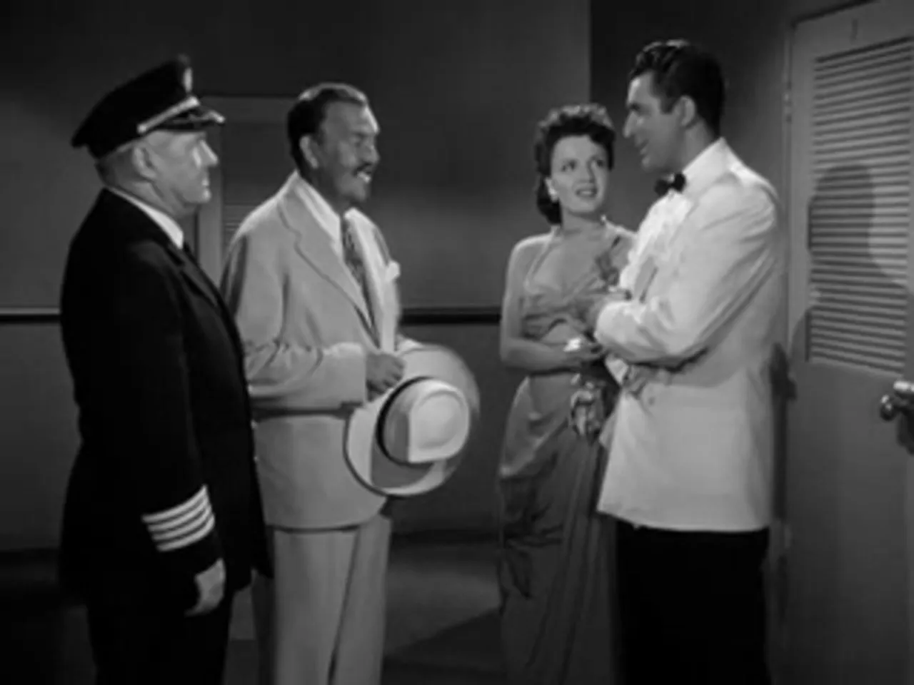 Dance in the ship's salon; Charlie Chan observes while others socialize