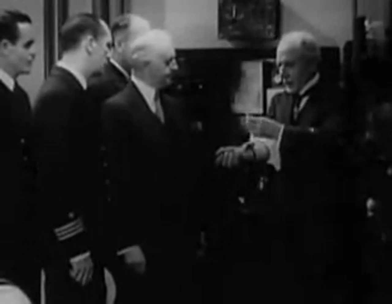Professor Grimson demonstrating the S-505 device, focused on the strange tube