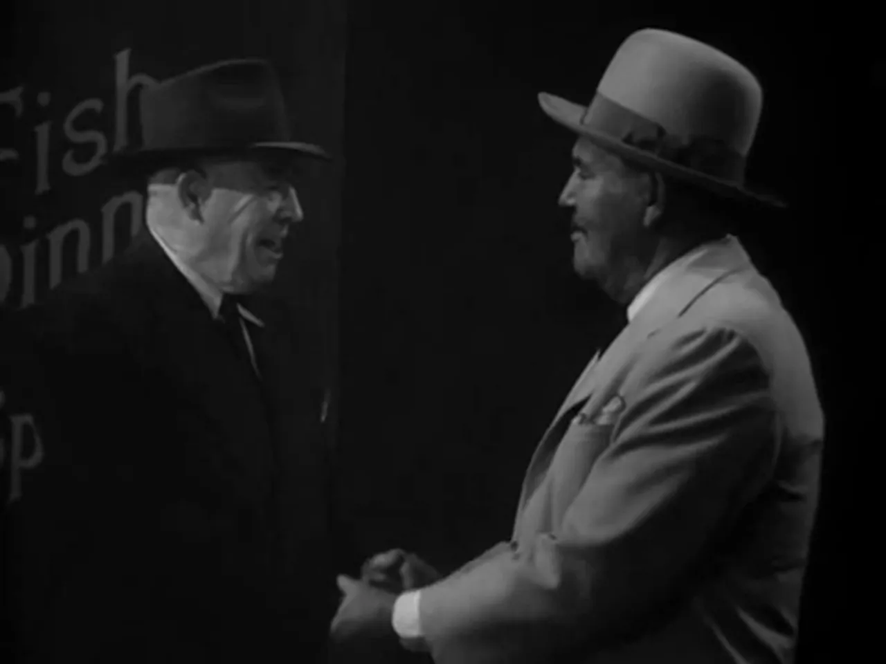 Captain Flynn and Charlie Chan greet each other at dock