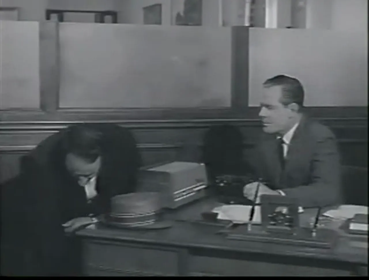 Fred Dorella kneads Ken for cooperation: the film noir movie places its moral trial at a bank counter.