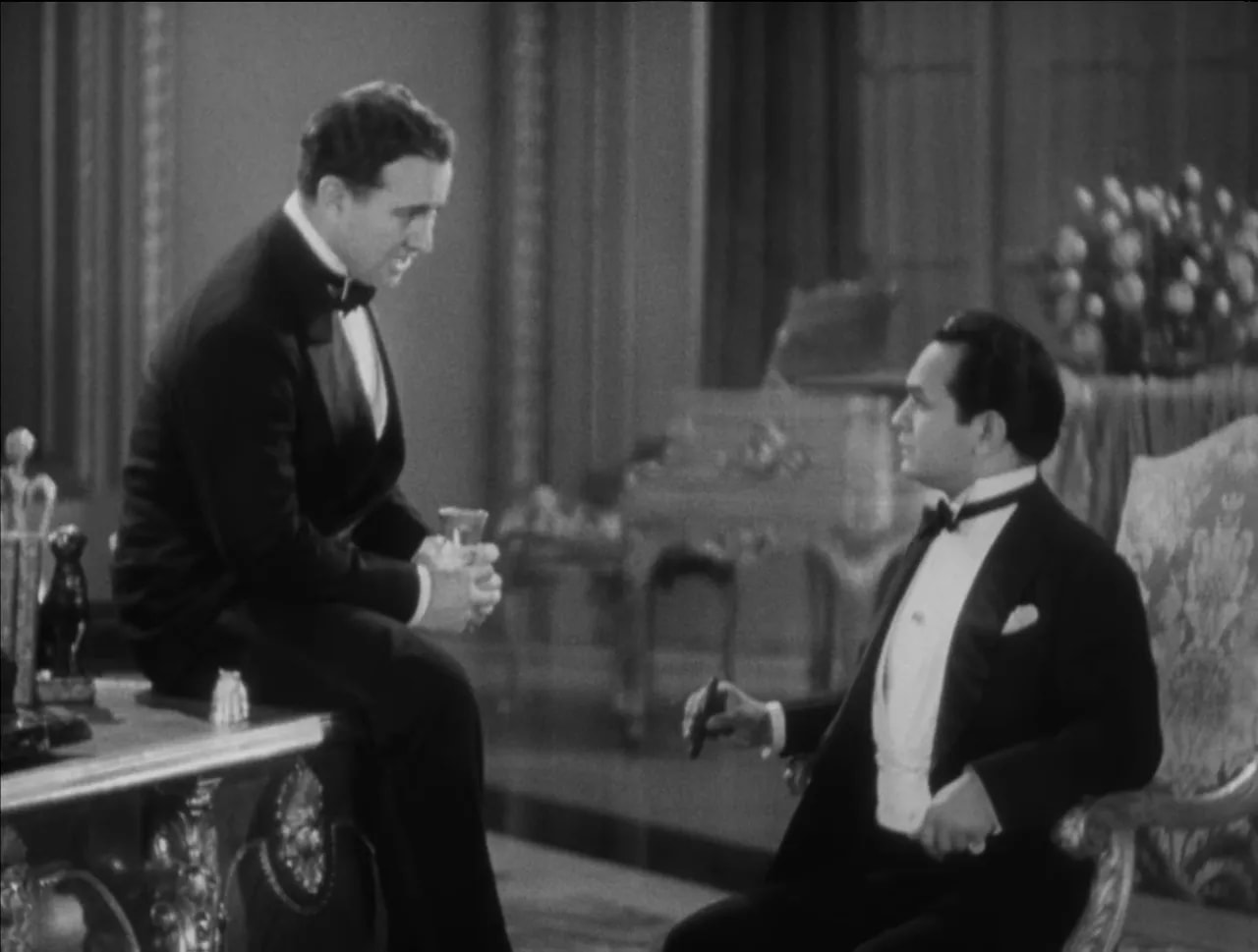 Little Caesar black-and-white banquet scene with Rico seated in a tuxedo holding a glass